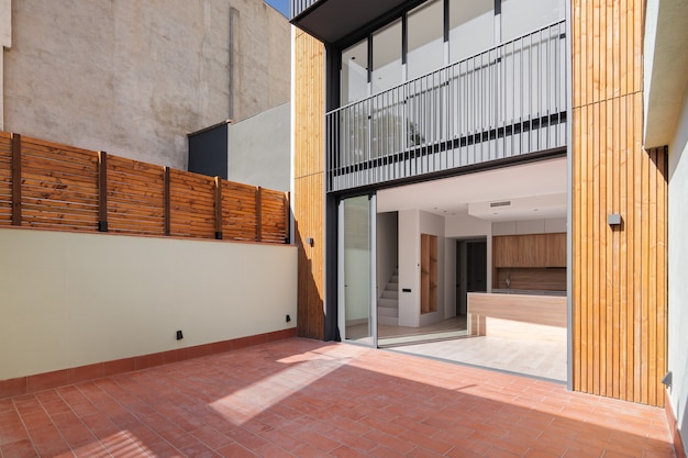 Sunny view of the patio of refurbished apartment in contemporary building outdoor exterior of narrow...