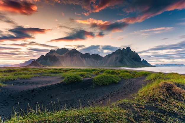 Sunrise dramatic sky over Vestrahorn mountain on black sand beach in Stokksnes peninsula at Iceland