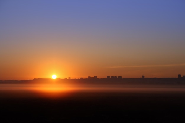 Sunrise over far town