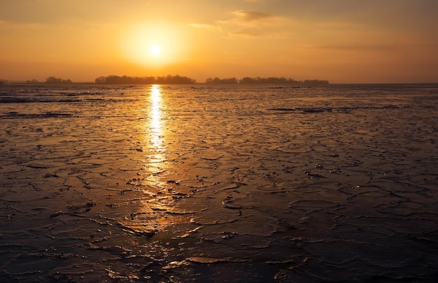 Sunrise and frozen sea Beautiful winter landscape with lake in morning time