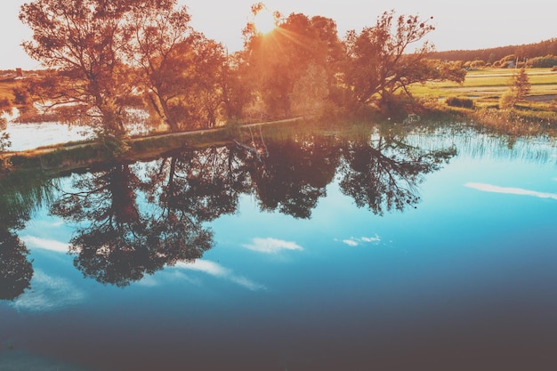 Sunrise over the lake in autumn Rural landscape in evening