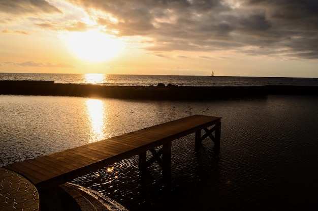 Sunrise on a Pier over Atlantic Ocean in Tenerife Canary Islands Spain