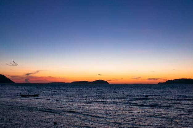 Sunrise in Rawai with long tail boat