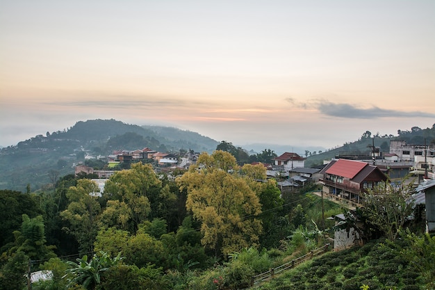 Sunrise scene with the peak of mountain and cloudscape and town landscape