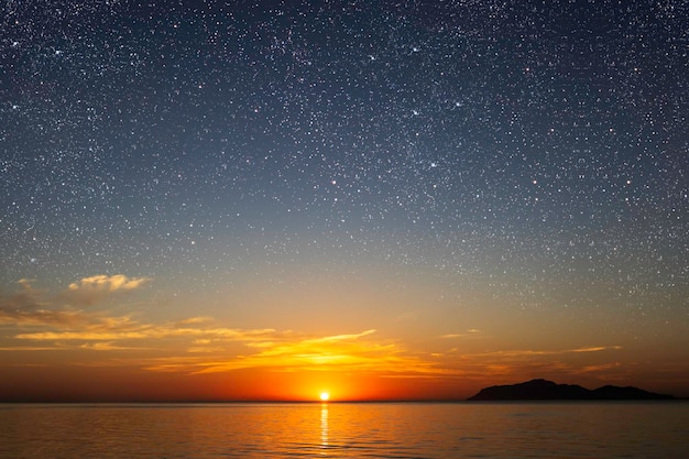 a sunrise at sea with beautiful gradient and stars