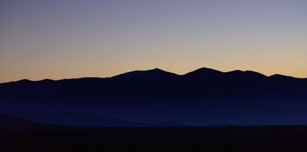 Sunrise or sunrise over mountains silhouette with blue sky background Panoramic view banner