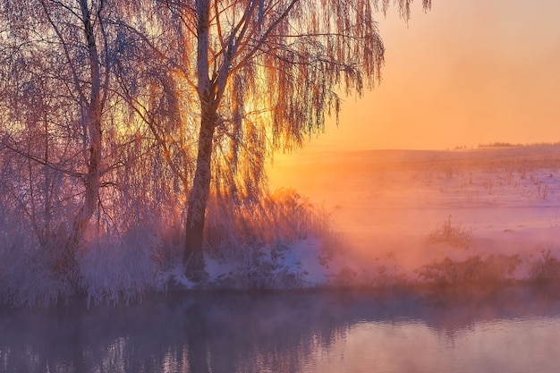 Sunrise in winter on the river bank