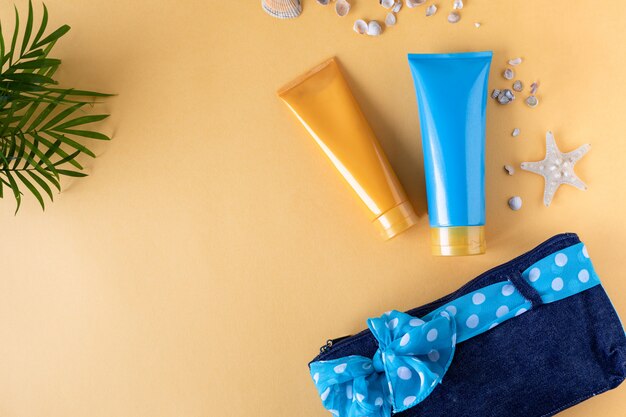 Sunscreen bottles and a starfish on a yellow background