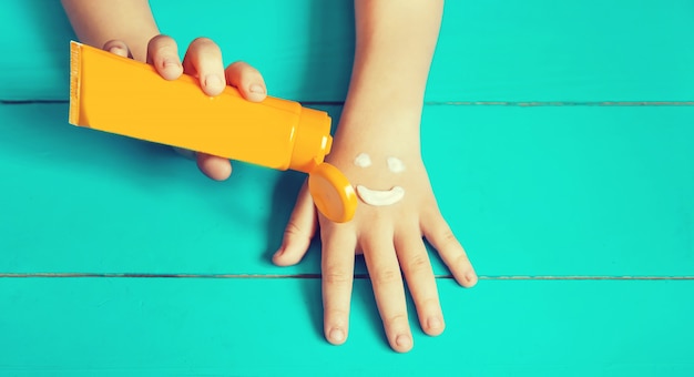 Sunscreen on the hand of a child. 