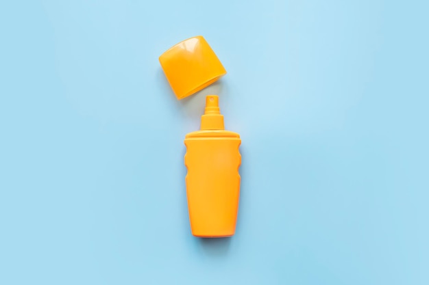 sunscreen orange bottle sun protection on blue background spray to protect against sunburn different spf values for sun protection cream