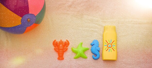 Photo sunscreen and toy molds with copy space on a terry cloth