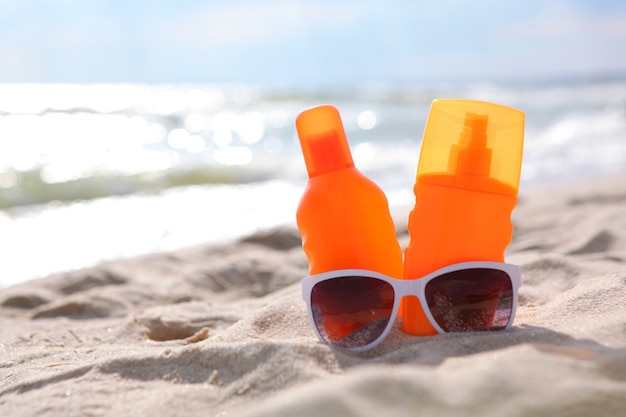 Sunscreens on the beach near the sea close up