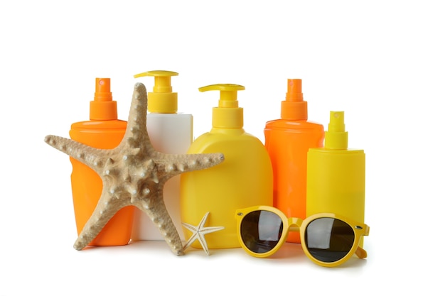 Sunscreens and summer accessories isolated on white