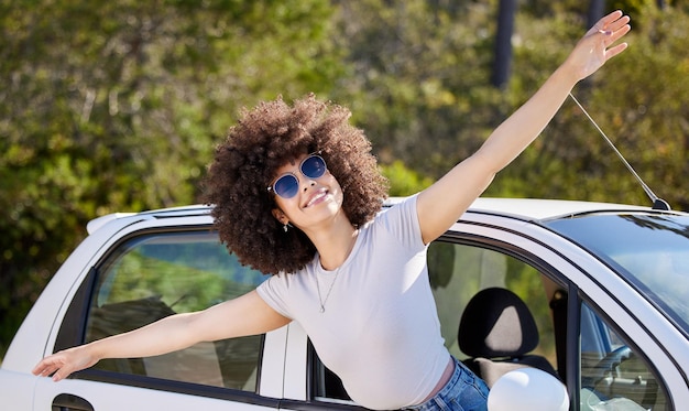 Sunset adventures Shot of a beautiful young woman enjoying an adventurous ride in a car