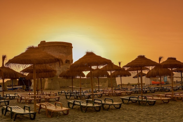 Sunset atmosphere on Cabo de Gata beach with historic watchtower