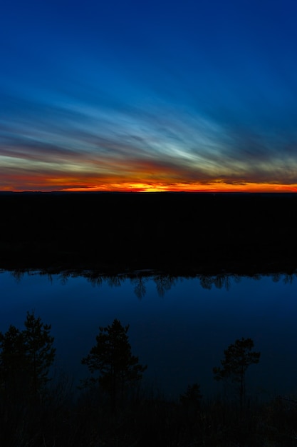 Sunset on the background of the smooth surface of the river.