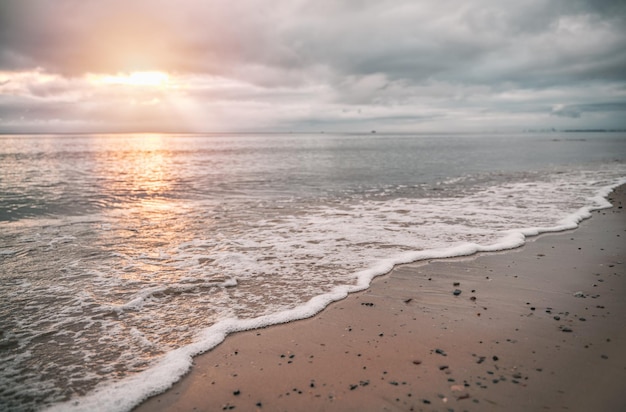 Sunset over the Baltic Sea with dramatic clouds with sun god rays