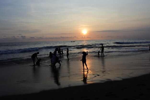 Sunset on the beach in sanur bali is a charming beach paradise silhoutte on beach