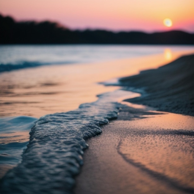 a sunset over a beach with the ocean in the background.