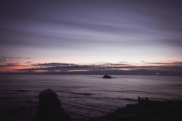 Sunset at beach with streaking wispy clouds