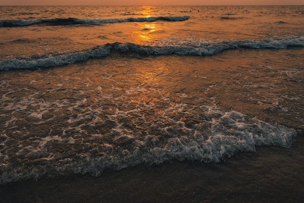 Sunset on the beachGolden sea waves at sunset