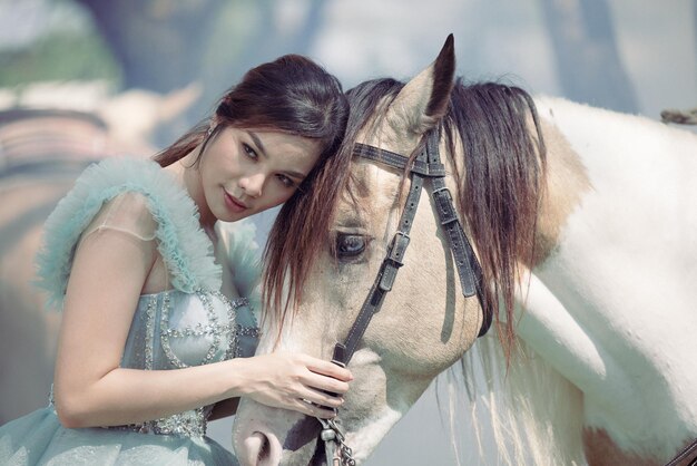 At sunset a beautiful sensual girl and her horse go through the woods Horses are adored by girls