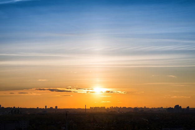 Sunset in the big city. Buildings, sun and dramatic orange sky