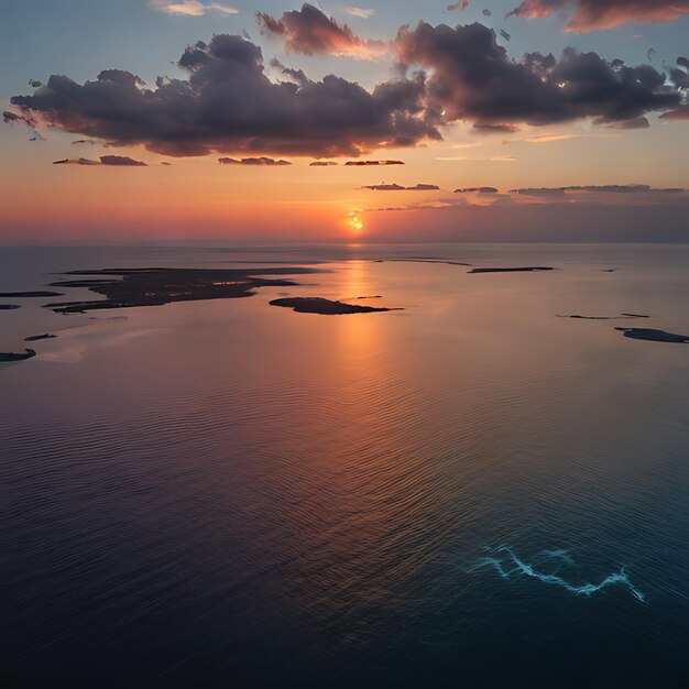 Photo a sunset over a body of water with a few clouds in the sky