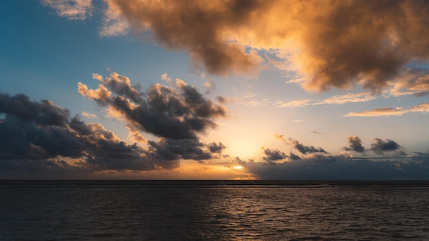 a sunset over a body of water with a sunset in the background