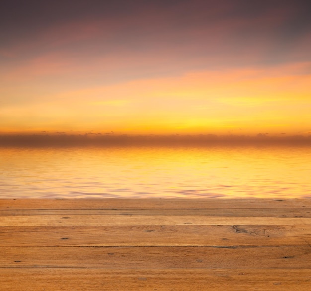 Sunset over calm off wooden deck