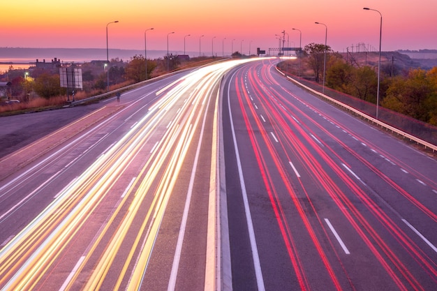 Sunset Car Traffic With Light Trails on a Suburban Highway