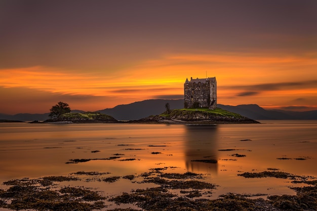 Sunset over Castle Stalker Scotland United Kingdom