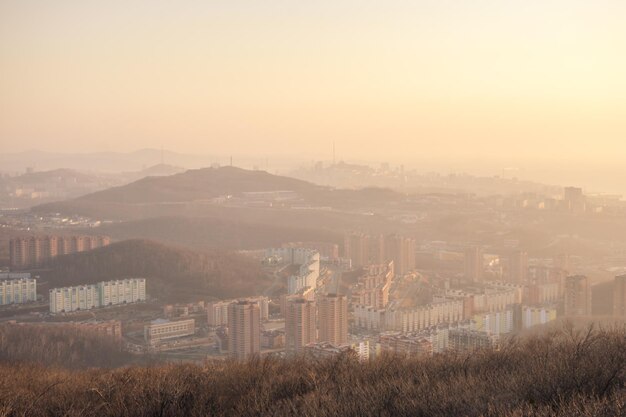 Sunset over the city between the mountains in spring