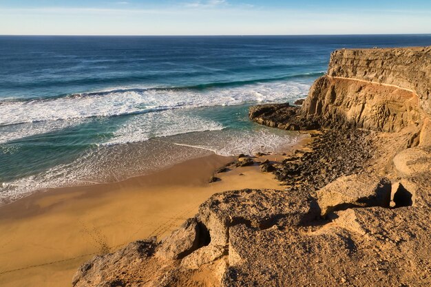 Photo sunset over the cliffs of the spectacular eagle beach also known as the ladder beach