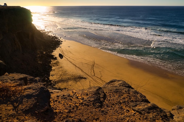 Sunset over the cliffs of the spectacular Eagle Beach also known as the Ladder Beach