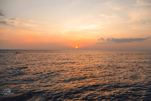 Sunset and Clouds over the OceanWoman watching the sun set