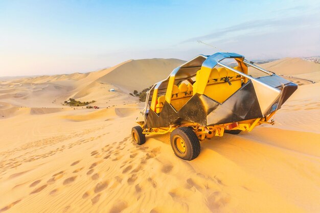 Sunset in the desert and a buggy Dunes of Ica Peru