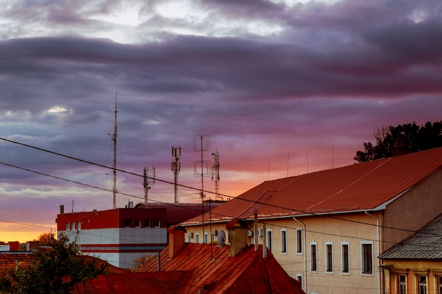 Sunset evening sky pink clouds of the roof of the houses of Uzhhorod city, Ukraine