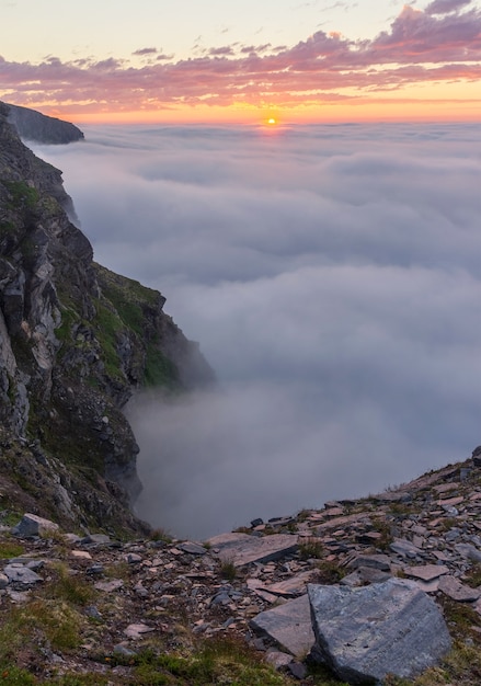 Sunset in the fog on the rocks of Soroya Island, Norway