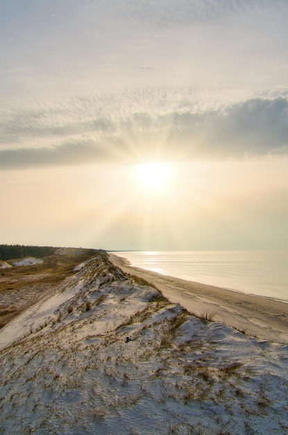 Закат на высокой дюне на пляже Дарсс Небо и море Балтийского моря