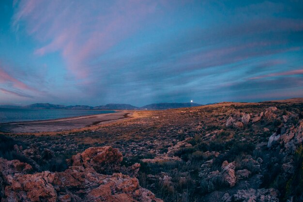 Sunset in the hills near the lake stones rock moon valley