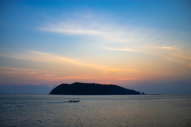 Sunset Behind an Island in the Sea at Koh Phaghan in Suratthani Thailand.