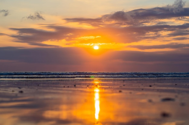 Sunset on the Kuta beach with reflection in the water on the island of Bali