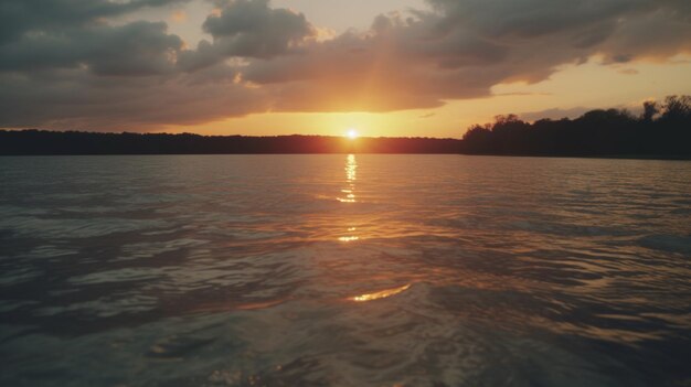 A sunset over a lake with a forest in the background