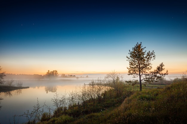 Sunset landscape with river shore