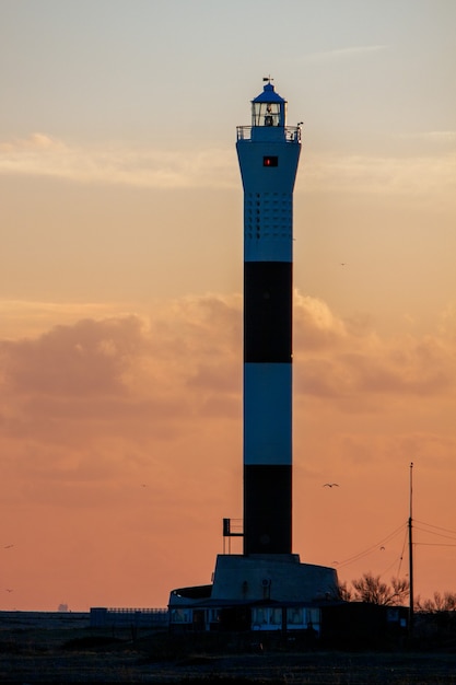 Sunset behind the Lighthouse on the beach at Dungeness in Kent