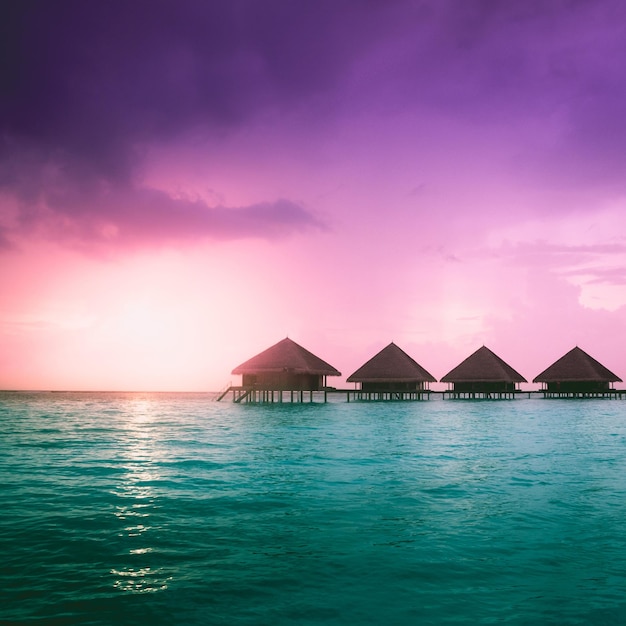 Sunset on Maldives island water villas resort