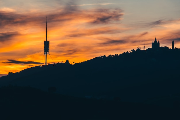 A sunset in the mountain with the barcelona city