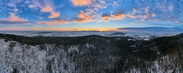 Sunset over mountains covered with forest