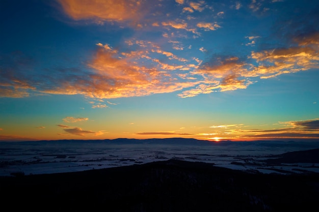 Sunset over mountains covered with forest